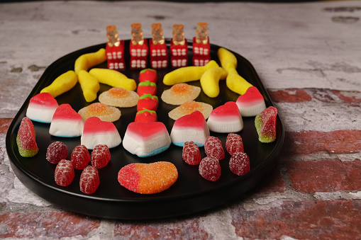 various types of assorted jelly candies in black tray