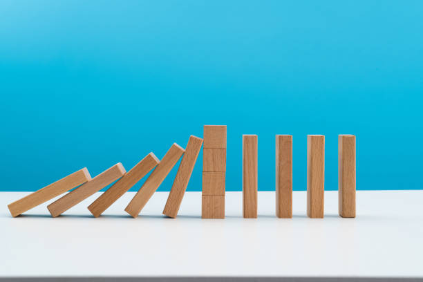 istock Wooden blocks stop other falling dominos 1456117566