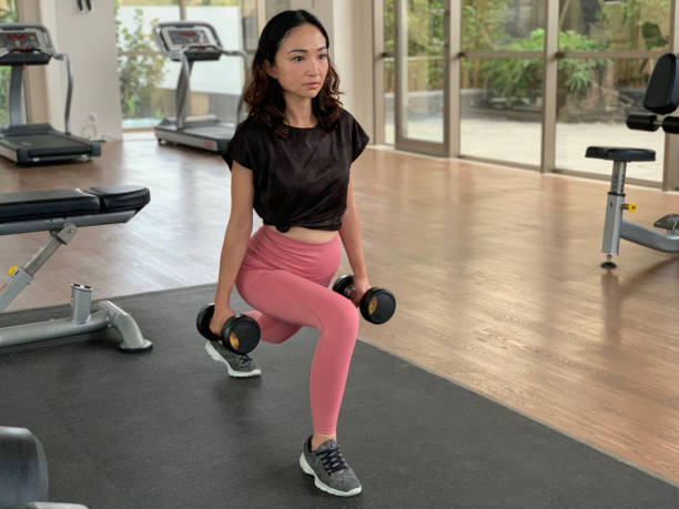 Asian Woman Lifting Dumbbell for Upper Body Training
