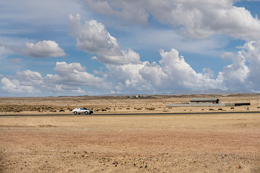 car speeding on the highway in the heat of the Namib desert