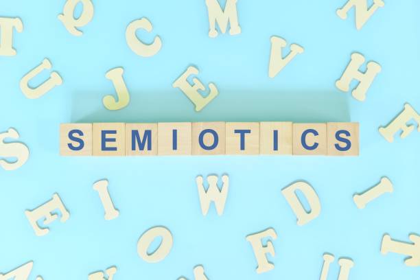 istock Study semiotics in linguistics concept. Wooden blocks word typography flat lay in blue background. 1456121112
