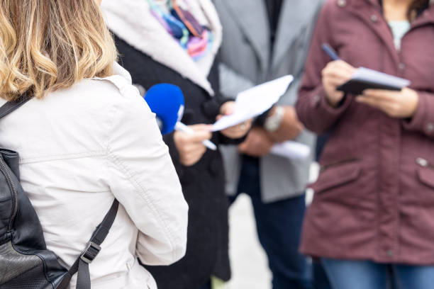 istock News Reporter Holding Microphone, Journalist Taking Notes During Media Interview Or Press Conference 1456123724