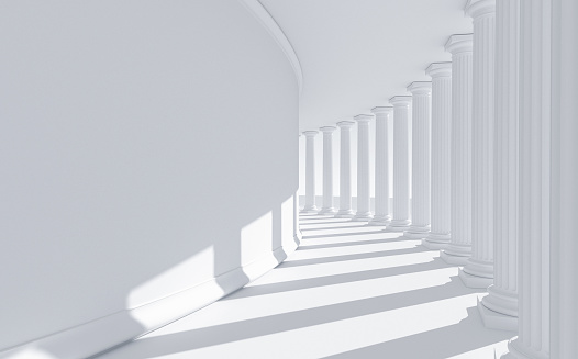 Abstract building with a bent row of white columns casting shadows on a curved wall. Abstract architecture resembling a government building dedicated to law, justice and education: strength, stability and order. Digital image with copy space on left side.