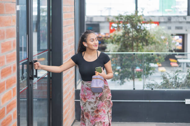 istock Hispanic young female opening a door 1456126340