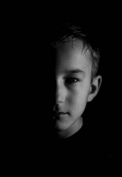 istock Young Caucasian  boy portrait against black background 1456127455
