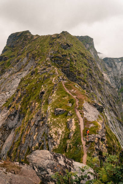 istock Vertical shot of a mountain with rocky and sharp slopes and a mountain climber 1456127584