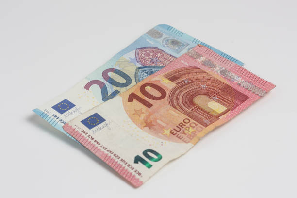 istock 20 and 10 euro banknotes on a white background 1456127890