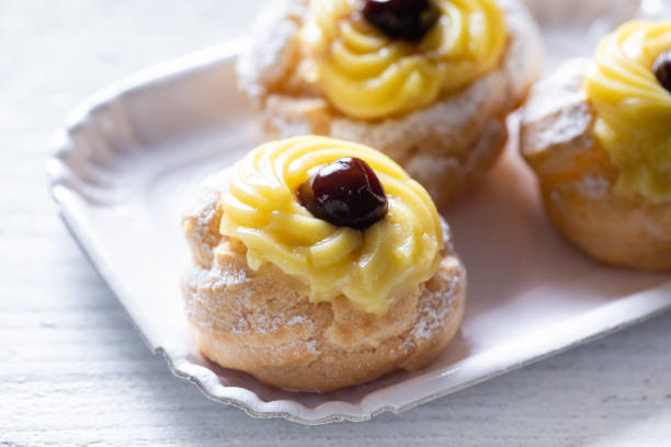 Zeppole pastry from south italy Zeppole home made pastry from naples, typical for father day and st joseph saint joseph stock pictures, royalty-free photos & images