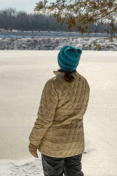 istock Woman with a blue hat standing in a snow 1456130471