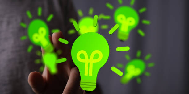 istock Man's hand choosing a 3d rendered light bulb - Concept of green energy 1456131589