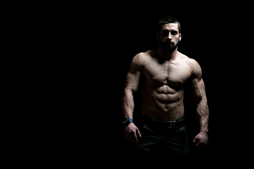 Young Bodybuilder Flexing Muscles - Isolate on Black Blackground - Copy Space