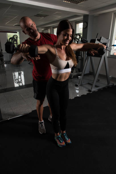 istock Shoulder Exercising With Dumbbells In Gym 1456133073