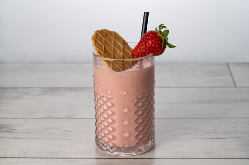 strawberry smoothie with natural fruit, white background and copy-space