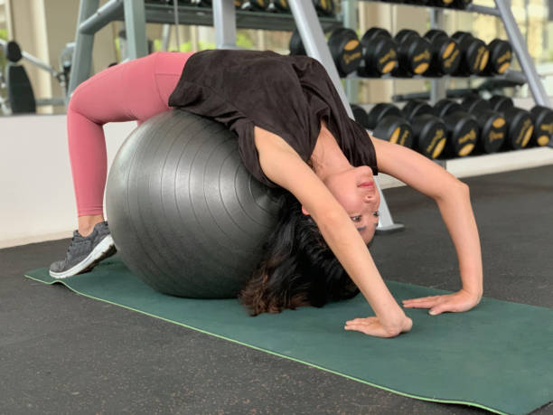 istock Asian Woman Doing Backbends With Pilates Ball 1456134774