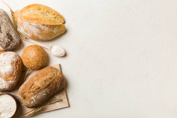 istock Homemade natural breads. Different kinds of fresh bread as background, top view with copy space 1456135149