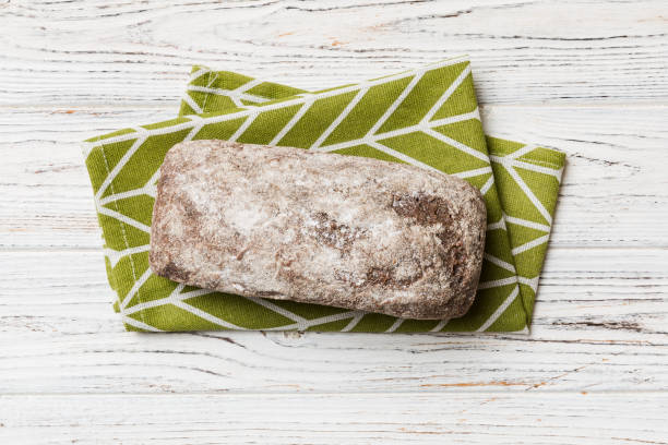 istock Fresh rye bread on napkin on rustic background, fresh bread top view 1456135170