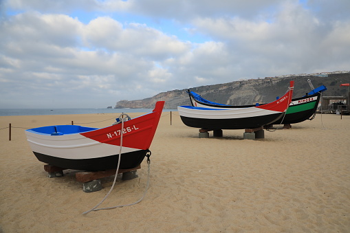Nazare, Portugal - November 11, 2021: Portugal s most famous fishing village. Along the seafront of Nazare, colorful fhishing boats ready to sail