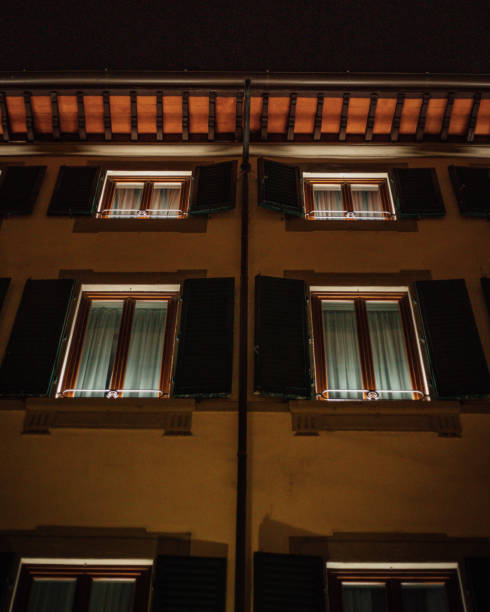 istock Vertical bottom shot of a building with illuminated windows. 1456137259