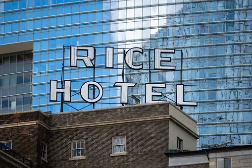 Houston, United States – April 22, 2022: A Rooftop sign for the Rice Hotel in downtown Houston, TX