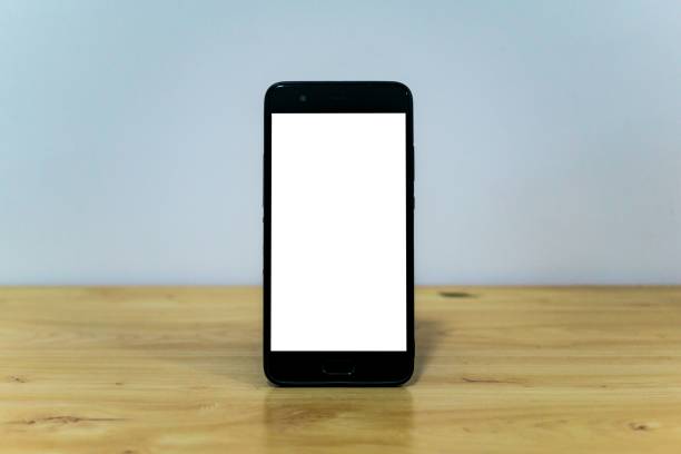 istock Smartphone with a blank screen with a copy space on a wooden table 1456139315