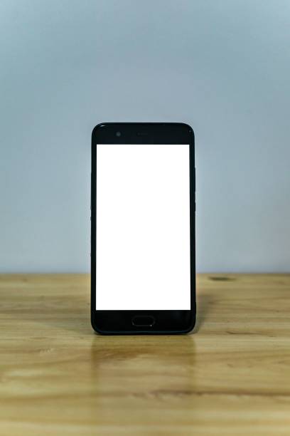 istock Vertical shot of a smartphone on the table with a white screen for the copy space 1456139472