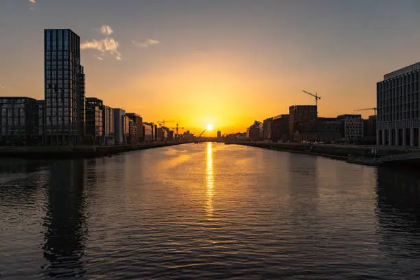 Photo of Beautiful view of sunset at Samuel Beckett Bridge crossing the River Liffey. Dublin, Ireland 2021