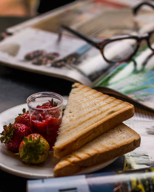 A breakfast plate at a restaurant with fresh strawberries and toast
