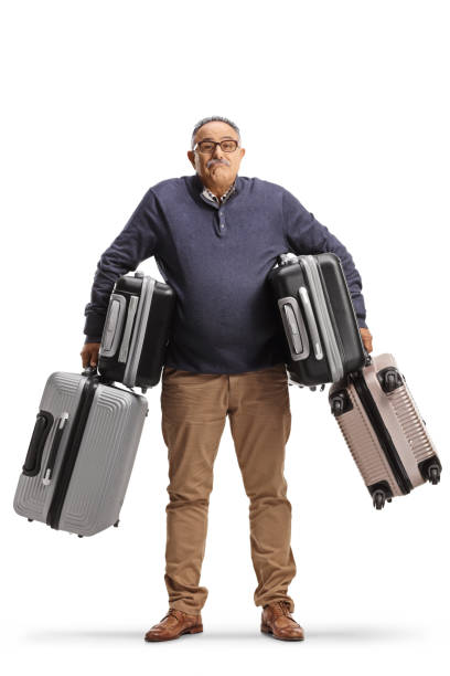 istock Confused mature man carrying many suitcases 1456142390