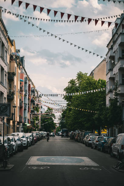 istock Vertical shot of a beautiful narrow street decorated with colorful triangular flags 1456142912