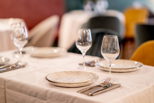 istock Shallow focus beautiful table setting with crockery and glasses for an event in the restaurant 1456143342