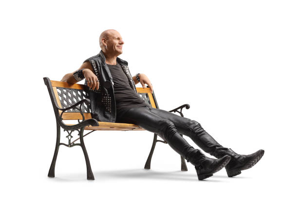 istock Man in a leather vest and pants sitting on a bench 1456143599