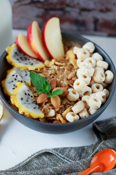 istock Healthy fruit bowl filled with cereal, apple, dragon fruit, and milk 1456143873