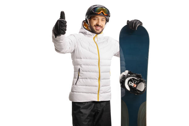 Young man leaning a snowboard and gesturing thumbs up Young man leaning a snowboard and gesturing thumbs up isolated on white background thumbs up for skiing stock pictures, royalty-free photos & images