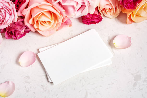 istock White card mockup with pastel roses on white marble table 1456153564
