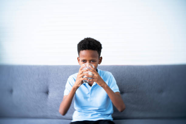 African-American Ethnicity teenage boy drinking milk from mug