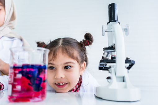 Little girl awaits the results of a scientific experiment