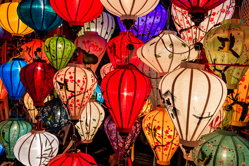 Asian ( Chinese / Vietnamese ) traditional silk hanging lanterns lanterns, night market in Hoi An. Hoi An is situated on the east coast of Vietnam. Its old town is a UNESCO World Heritage Site because of its historical buildings.
