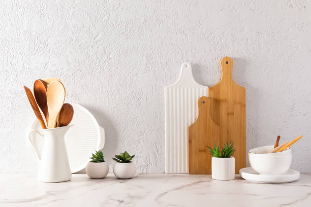 istock various kitchen utensils on a white marble countertop in a modern kitchen. the concept of decor against the background of a textured gray wall. 1456157987
