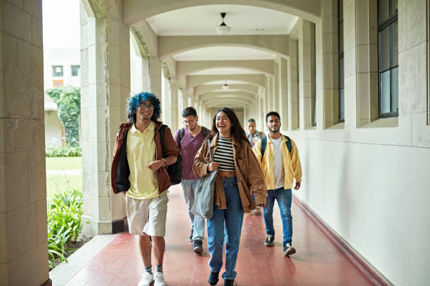 istock College friends laughing and talking on the way to class 1456160598