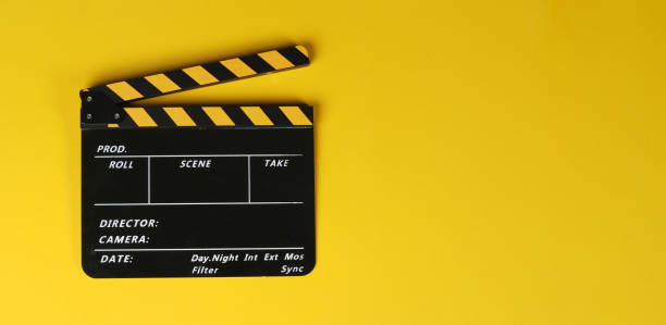 istock Clapper board or movie slate on yellow background. 1456160854