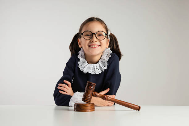 Children's Rights 8 years old girl holding gavel. childrens rights stock pictures, royalty-free photos & images
