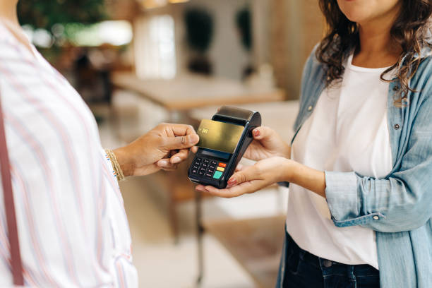 istock Store owner receiving a credit card payment from a customer 1456164433