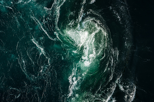 Heavy swirl of water due to strongest tidal current in the world in Saltstraumen in Norway landscape format