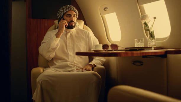 istock Professional speaking mobile phone in private jet. Businessman discussing work 1456165709