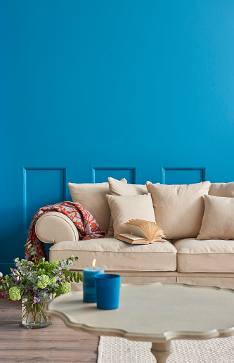 blue room cream armchair and decorative lamp.