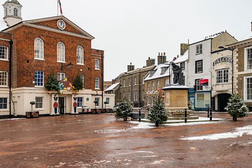 The centre of Huntingdon, Cambridgeshire, England, UK.  A Christmas tree and decorations outside the Town Hall.