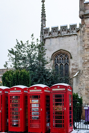 Cambridge telephone boxes in front of Great St Mary's Church in the historic university town of Cambridge, England, UK.