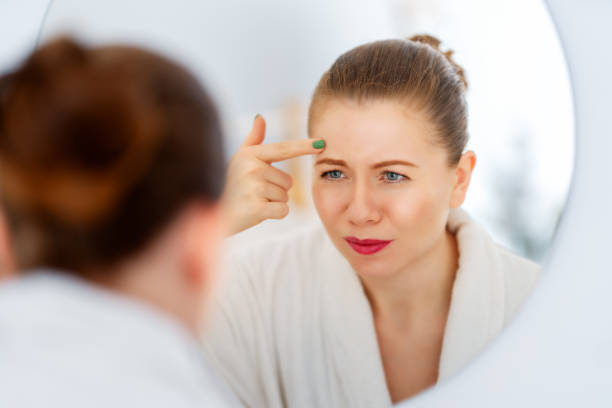 istock woman looking at wrinkles 1456166298