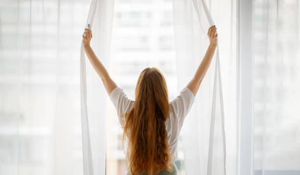 istock Woman opening the window 1456166388