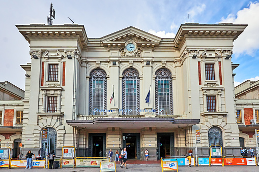 Prato, Italy - September 03, 2022: Pedestrians in front of the train station in Prato near Florence.